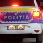 Rear view of a POLITIA police car with flashing red lights, license plate MAI 55492, pedestrians nearby