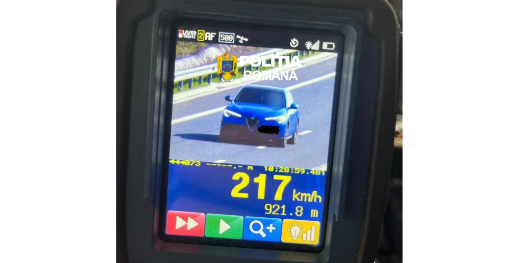 Police speed radar display showing a blue car on a highway, readout 217 km/h with Romanian police branding at the top.