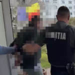 Police officer in a dark uniform with 'POLITIA' on the back restrains a person near a doorway outside, in a pixelated scene for privacy.