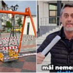 Orange playground swing set taped off with red-and-white barrier tape in a residential courtyard outside buildings.