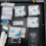 Open black case with several blurred boxes and a small lighter; logos for D.I.C.O.T. and Politia Română visible at top corners, suggesting seized evidence.