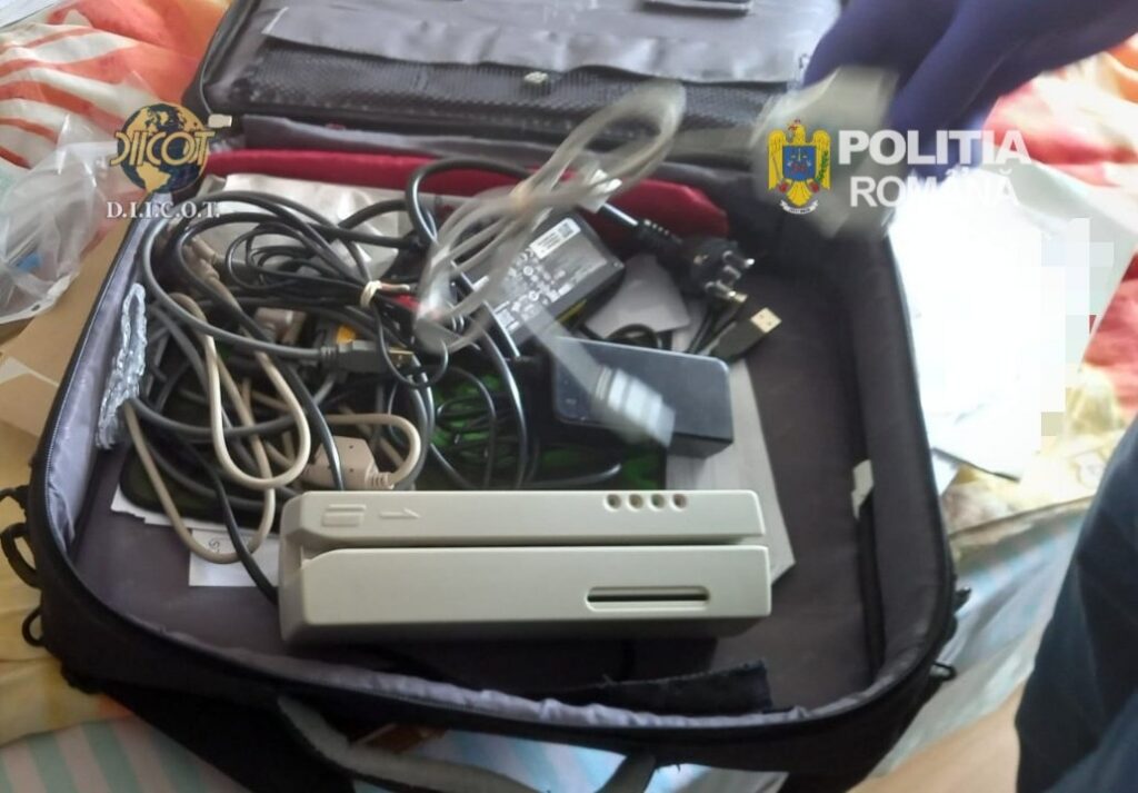 WhatsApp Image 2026-05-14 at 141104 - Jurnalul Olteniei – Știri din Craiova și Oltenia Open suitcase filled with tangled electronic cables and a gray Nintendo Wii console; police logos visible, suggesting seized evidence.