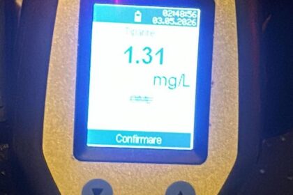 Handheld breathalyzer displaying a 1.31 mg/L breath alcohol level with a red LED indicator and an 'OK' button.
