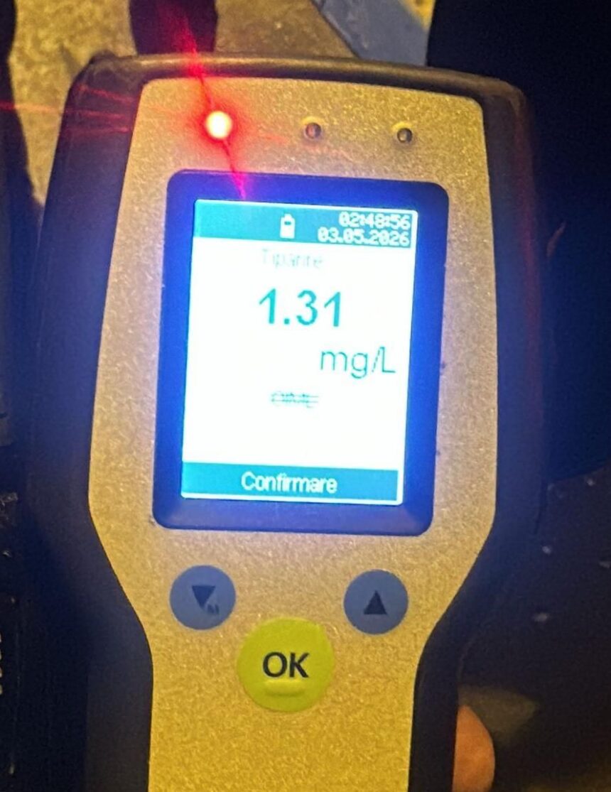 Handheld breathalyzer displaying a 1.31 mg/L breath alcohol level with a red LED indicator and an 'OK' button.