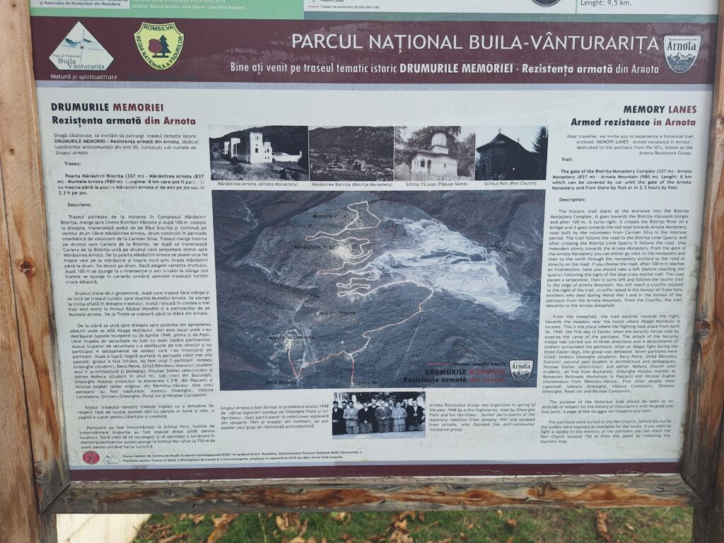Informational outdoor signboard about the Arnota resistance trail in a national park, with photos, a map, and bilingual Romanian–English text on historic sites.