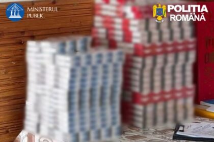 Blurred stacks of packaged goods on a table, with official logos from the Romanian Public Prosecutor's Office and Romanian Police in the corners.