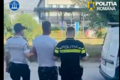 Three men walking away from the camera, one in a police uniform labeled POLITIA, near a white van at an outdoor area.