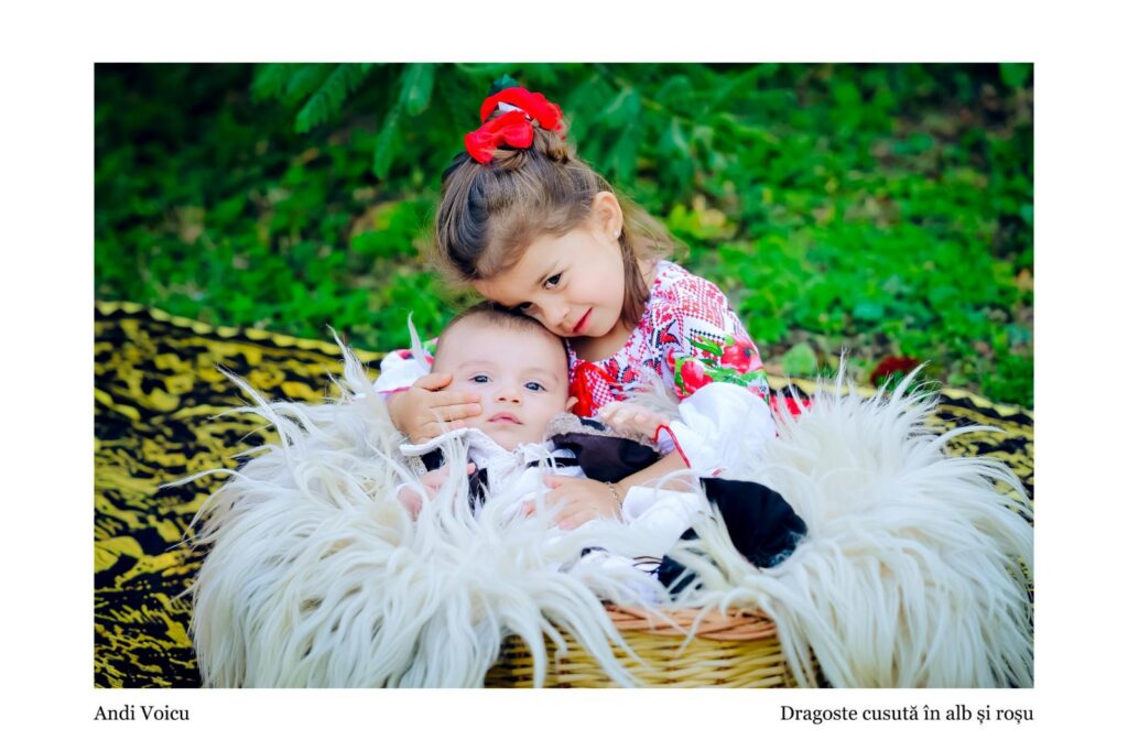 Young girl with a red bow cuddling an infant in a wicker basket lined with white fur, outdoors in greenery
