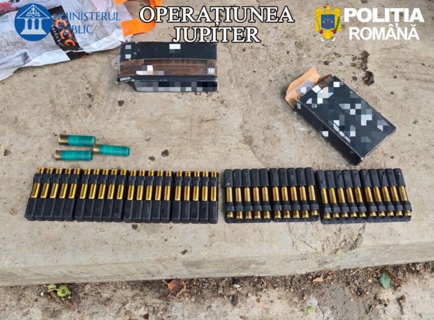 Row of black cartridge holders with gold-tipped bullets and a few green shotgun shells on a concrete surface, with opened boxes nearby and 'OPERATIUNEA JUPITER' and 'POLIŢIA ROMÂNĂ' branding