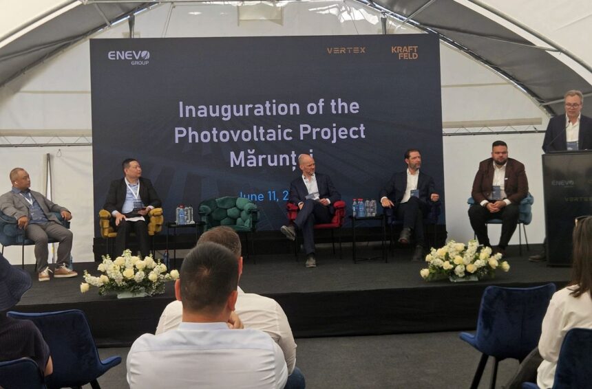 Panel discussion on stage for the Inauguration of the Photovoltaic Project, with a large branded backdrop behind the speakers.