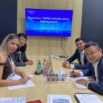Signing ceremony at a conference table with four professionals signing documents; screen behind reads 'Romanian 10MW/40MWh BESS Signing Event'.