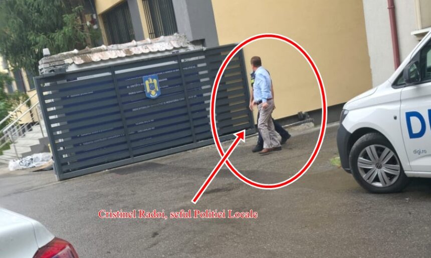 Man in a light blue shirt walks along a street beside a dark metal gate with a white police van nearby; the person is circled by a red outline and arrow and highlighted for emphasis.
