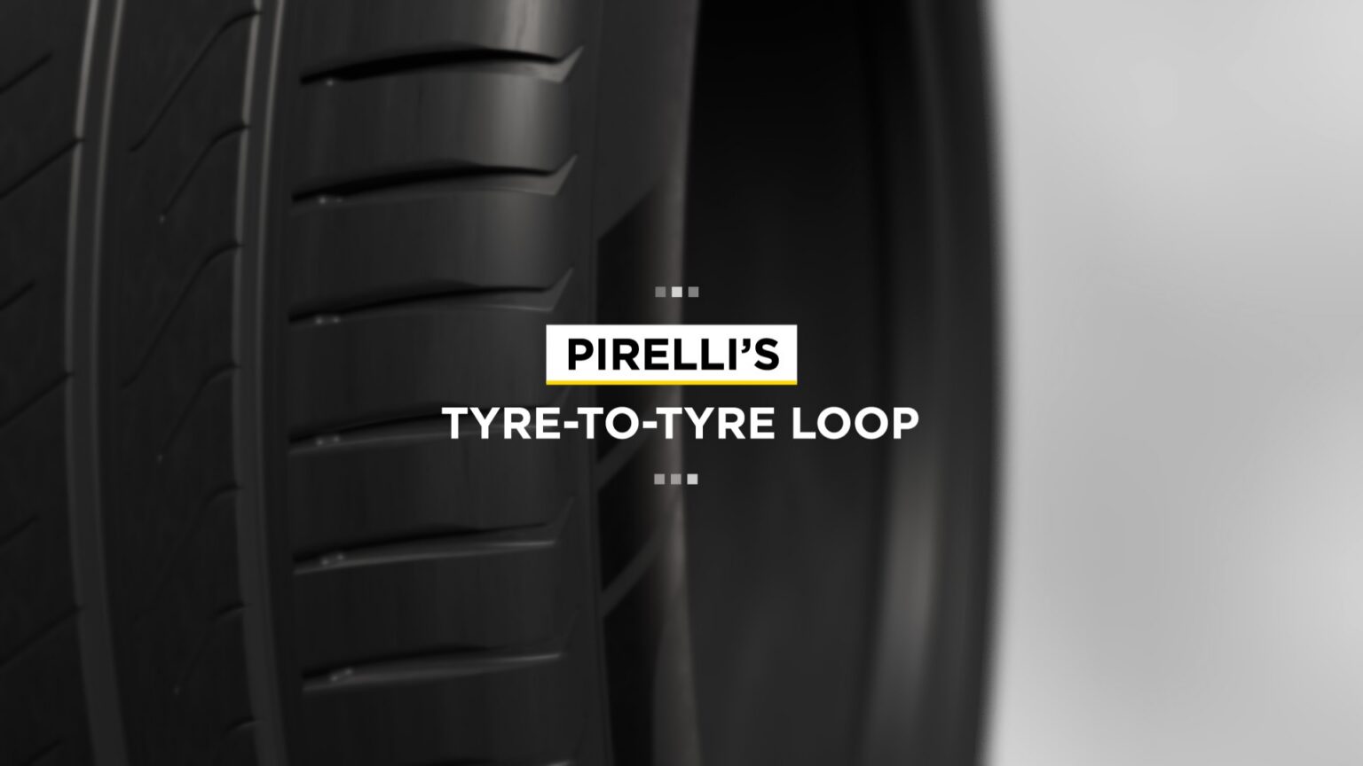 Close-up of a tire with the phrase "PIRELLI'S TYRE-TO-TYRE LOOP" displayed across the center of the image.