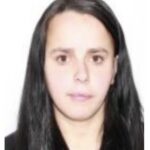 Portrait of a young woman with long dark hair facing the camera against a white background, neutral expression.