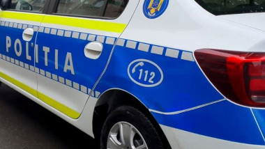 Police car with blue and white livery, 'POLITIA' branding, and 112 emergency number visible on the side.