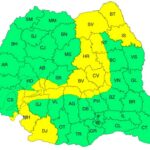 Color-coded map of a country’s districts with two-letter codes, mostly green and some yellow.