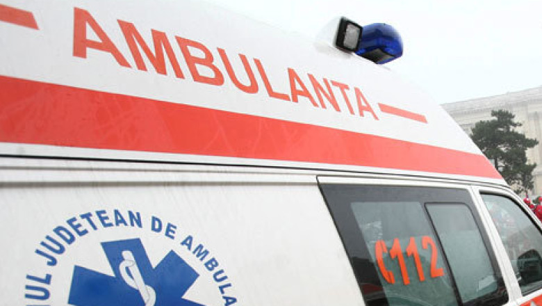 Ambulance with red stripe and the word 'AMBULANȚA' on the side, blue emergency light on top, 112 visible on the window side (Romanian emergency vehicle).