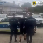 Three Romanian police officers in dark uniforms walk beside a marked police car in a parking area (police operation scene).