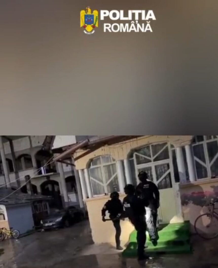 Romanian Police officers in tactical gear entering a building on a rainy day, under a police banner logo at top.