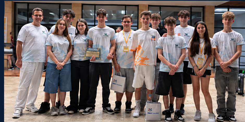 Group of fourteen young athletes posing in a gym, wearing matching light-blue shirts; two hold a plaque and certificates while others wear lanyards and carry bags.