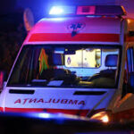 Front view of an ambulance with blue flashing emergency lights at night?