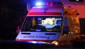 Front view of an ambulance with blue flashing emergency lights at night?