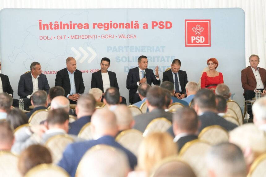 Panel of politicians seated on stage during a conference, backdrop with PSD logo and Romanian text, audience in foreground