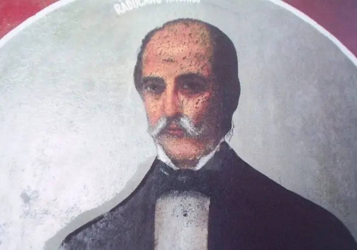 Portrait of a middle-aged man with a white mustache, wearing a dark suit and bow tie, facing forward.