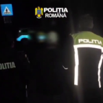 Romanian police officers in reflective jackets at night, with POLITIA marks visible on their backs.