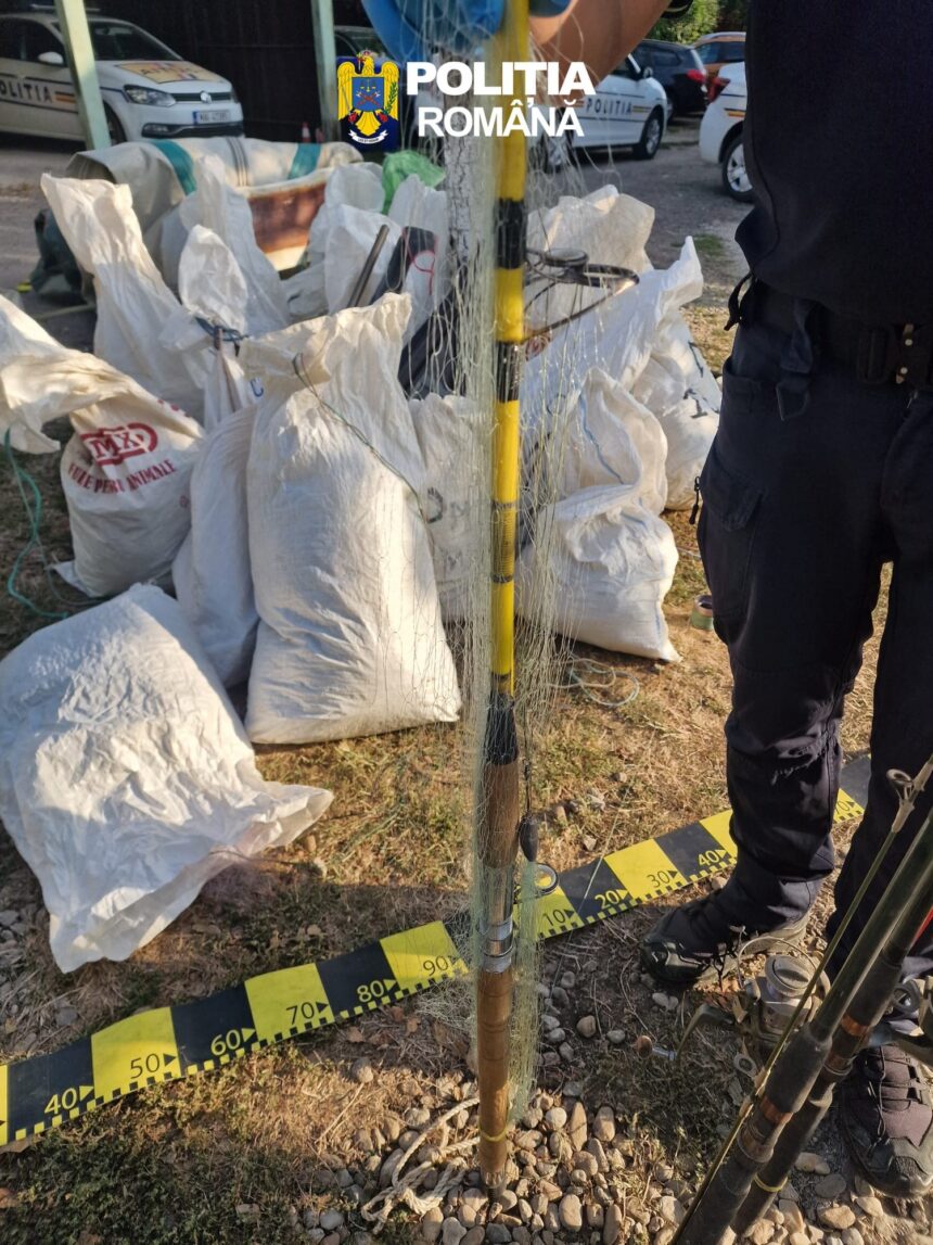 Pile of white sandbags around a cordoned-off area with police cars in the background.