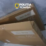 Two brown cardboard boxes stacked on a blue-tiled floor with blurred shipping labels; police watermark 'Politia Romana' in the corner.