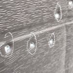 Close-up of a dark wooden plank with white chalk circles around small holes or screws