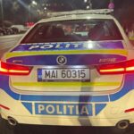 Rear view of a Romanian police car at night with red taillights, blue-yellow livery, and 'POLITIA' markings; license MAI 60315.
