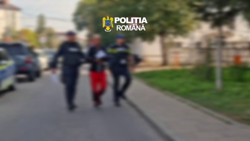 Two Romanian police officers escort a person down a sidewalk on a blurred street, with the 'Poliția Română' logo visible at the top.